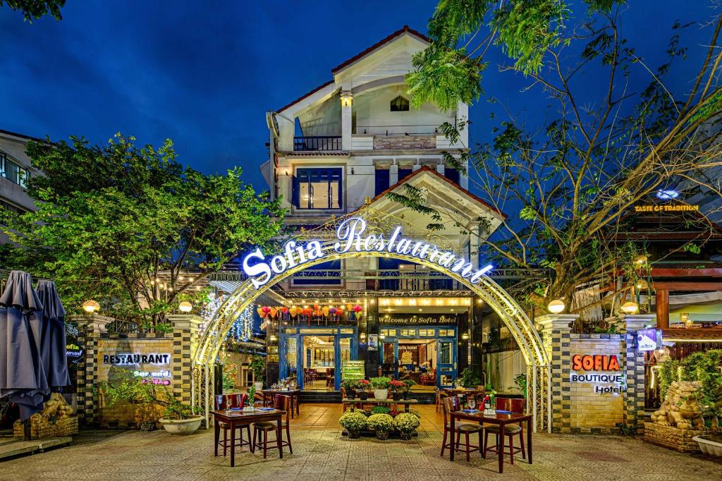 a building with an entrance to a restaurant with tables at Sofia Boutique Hotel in Danang