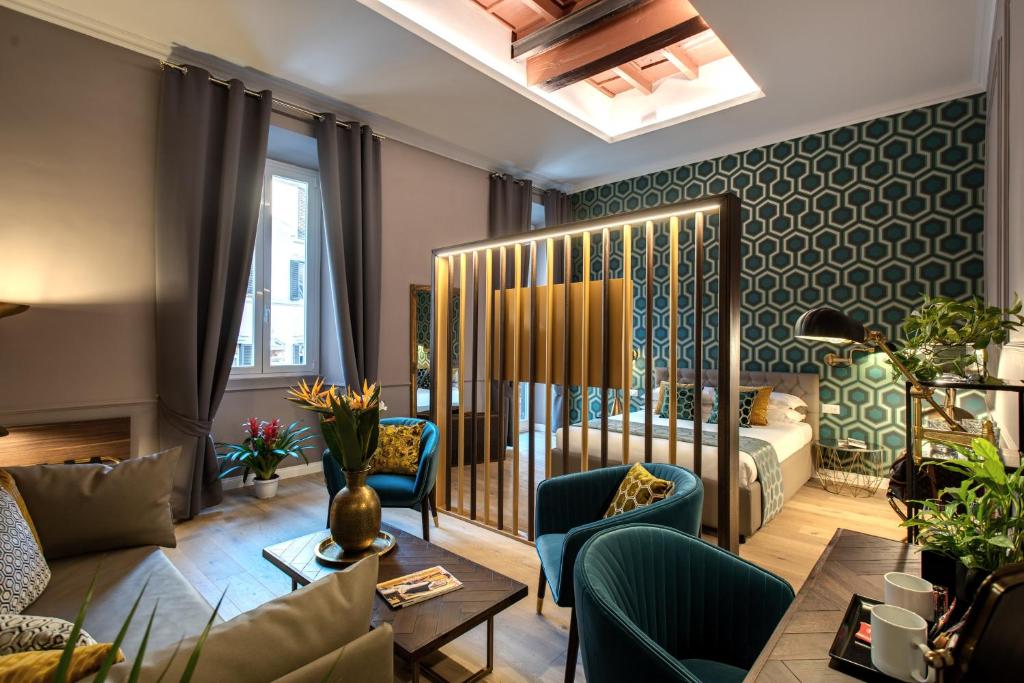 a living room with a bed and a couch at Tree Charme Parliament Boutique Hotel in Rome