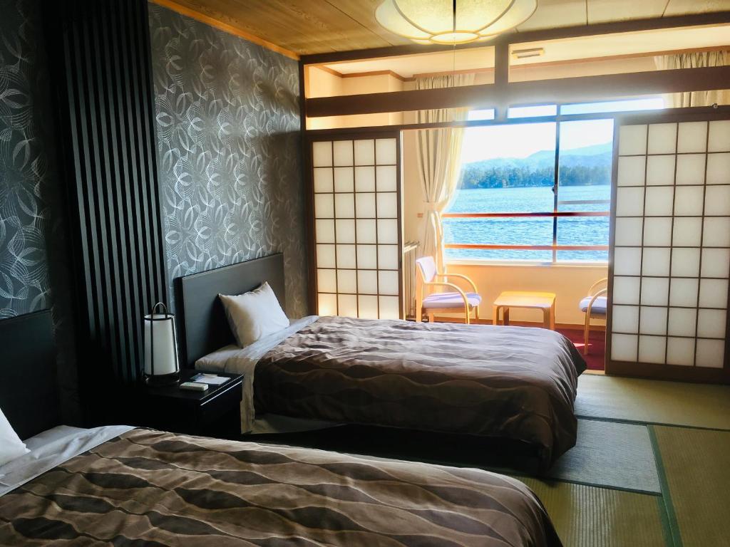 Postel nebo postele na pokoji v ubytování The Gran Resort Amanohashidate