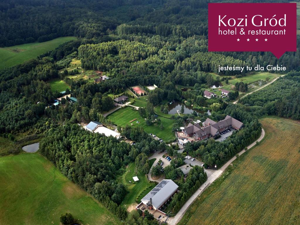 an aerial view of a house in a forest at Hotel Kozi Gród in Pomlewo