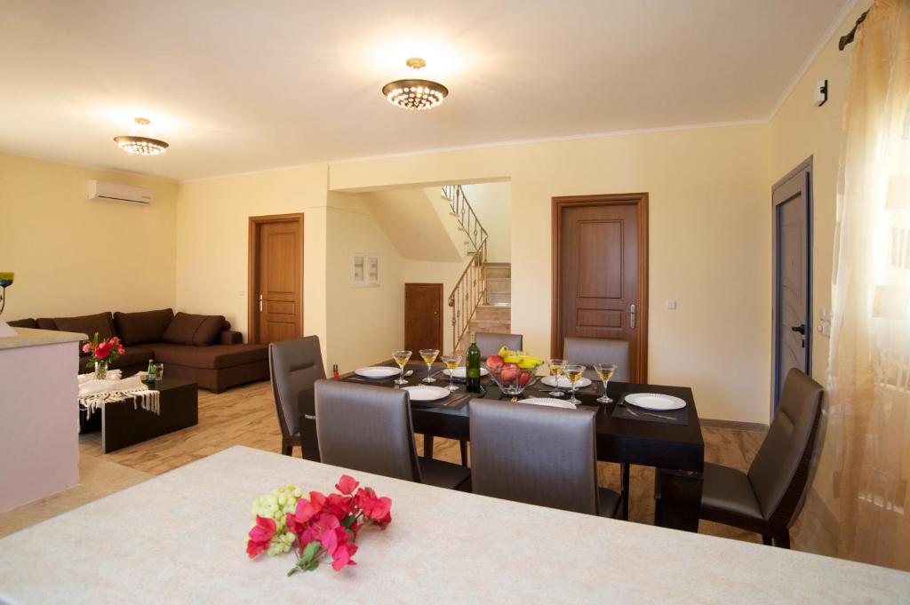 a dining room with a table and a living room at Sunrise Villa in Chaliotata