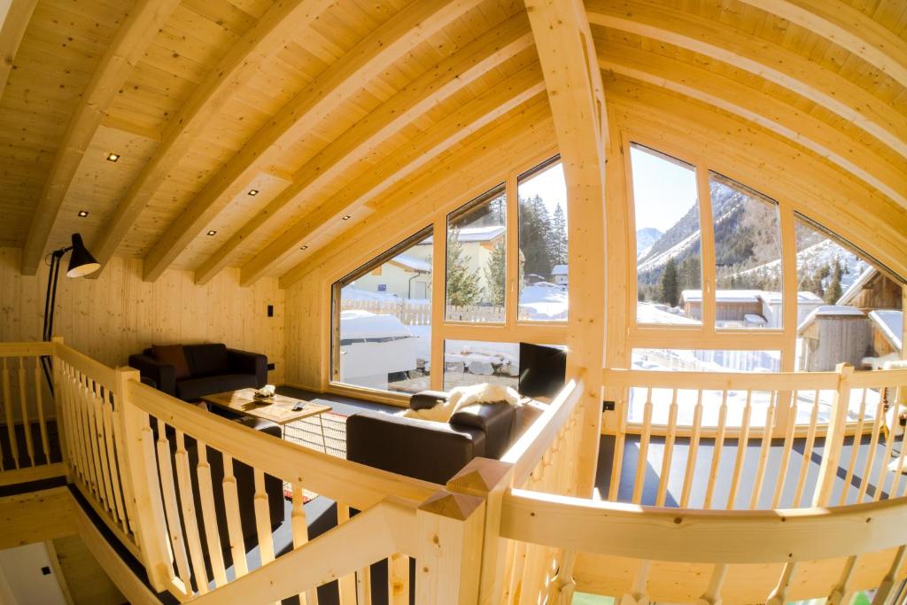 Aussicht vom Loft einer Blockhütte mit einem großen Fenster in der Unterkunft Ferienhaus Alpen Lodge und die Gams in Neurur