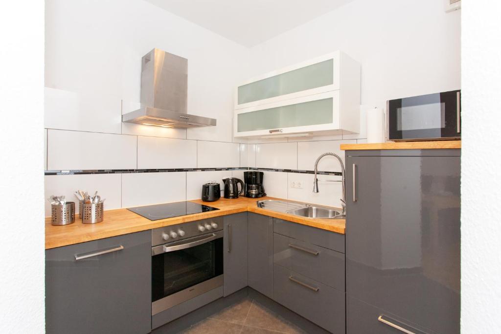 a kitchen with stainless steel appliances and a sink at Ferienwohnung Petersberg in Erfurt