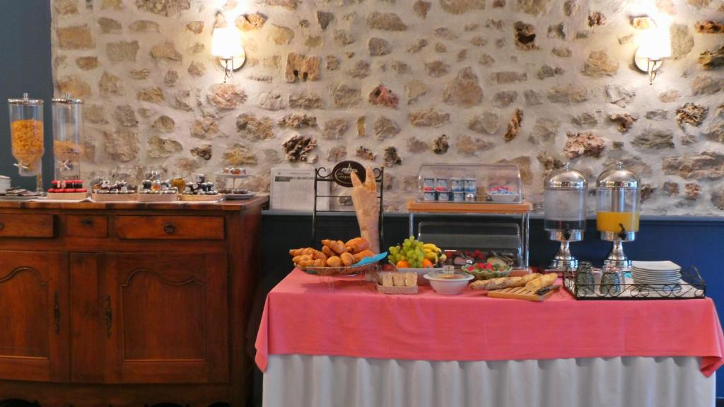 a table with a bunch of food on it at Hotel Relais Du Postillon in Antibes