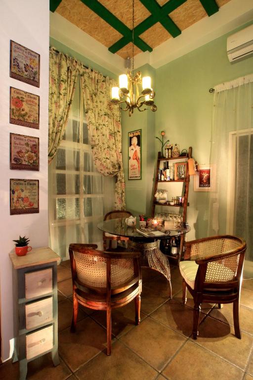 a dining room with a table and chairs and a chandelier at Happiness B&amp;B in Luodong