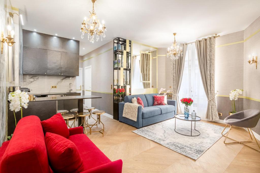 a living room with a red couch and a table at Luxury 2 Bedroom 2 Bathroom With AC -Eiffel Tower in Paris