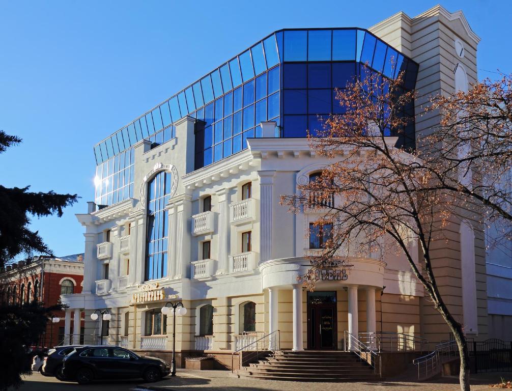 a large white building with a glass at Hotel Aristokrat in Poltava