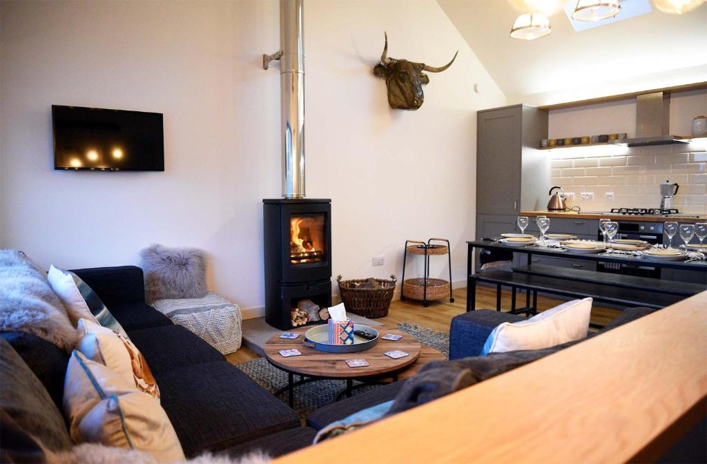 a living room with a couch and a fire place at Lodge on the Loch in Sconser
