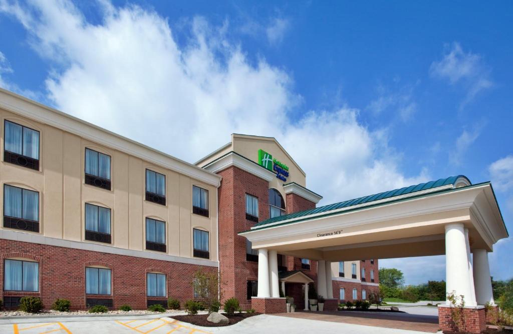 a hotel with a sign on the front of a building at Holiday Inn Express Hotel & Suites Tipp City, an IHG Hotel in Tipp City