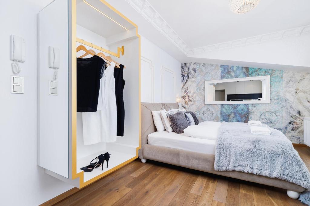 a bedroom with a bed and a dresser with a mirror at Modern Studio Węgierska Cracow by Renters in Krakow