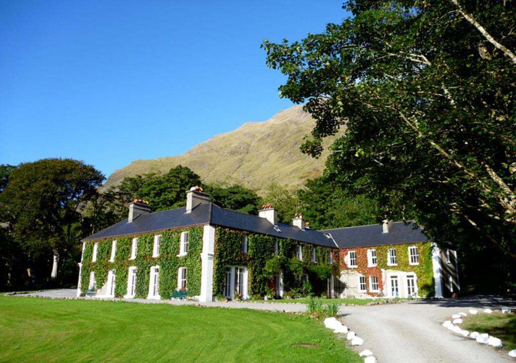 a large house in the middle of a road at Delphi Lodge in Leenaun