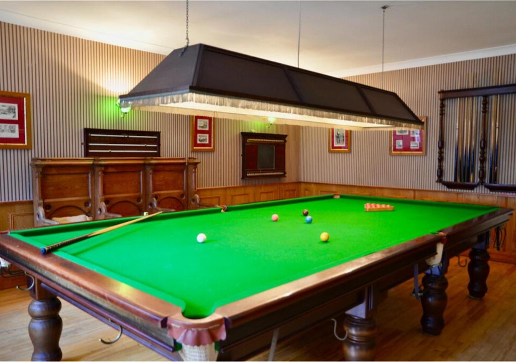 a pool table in a room with afits at Delphi Lodge in Leenaun