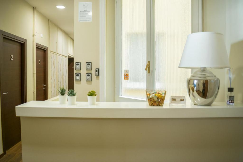 a white counter with a lamp and a window at Prati Comfort in Rome