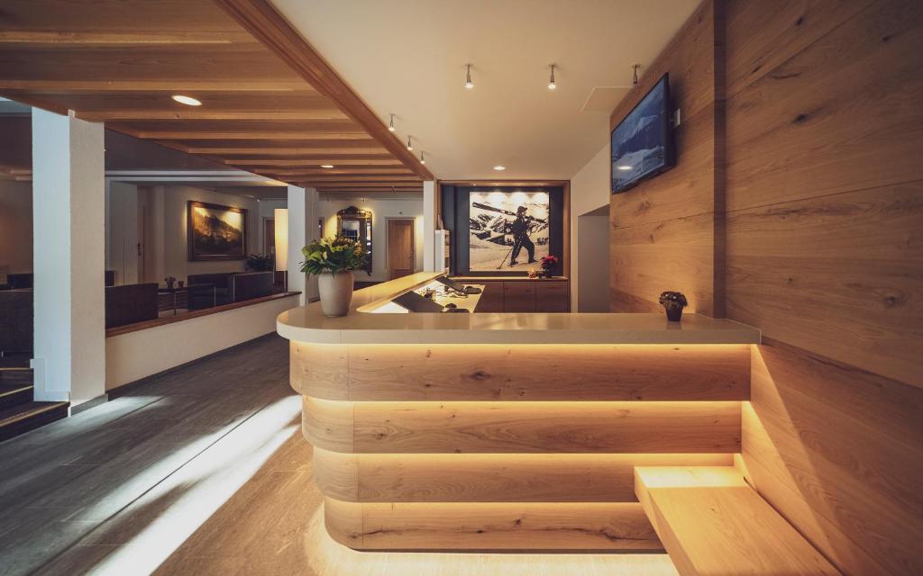 a large room with a bar with wooden walls at Hotel Strela by Mountain Hotels in Davos