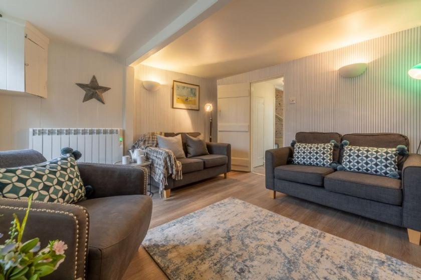 uma sala de estar com dois sofás e um sofá em No33 BRACKEN BOUTIQUE COTTAGE em Brancaster