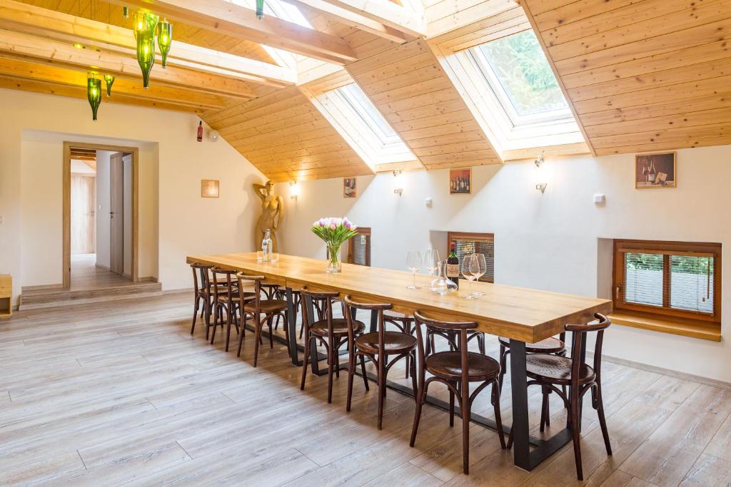 a large dining room with a long table and chairs at Vinný apartmán Rakovník in Rakovník