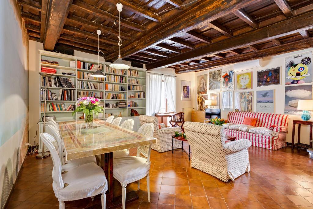 a dining room with a table and chairs at Rome as you feel - Luxury Cappellari Apartment in Rome
