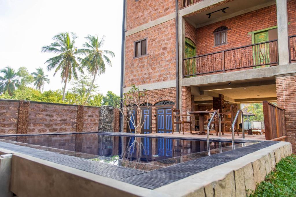 a house with a swimming pool in front of it at Negombo Boutique Villa in Negombo