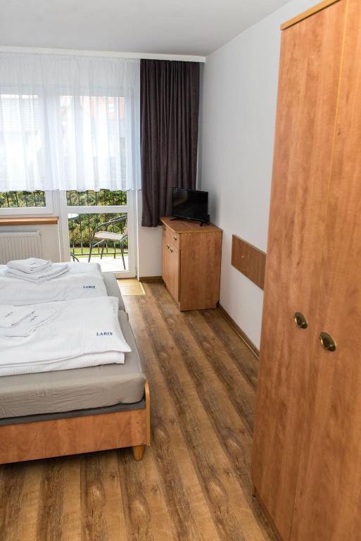 Postel nebo postele na pokoji v ubytování Dom Wczasowy Larix