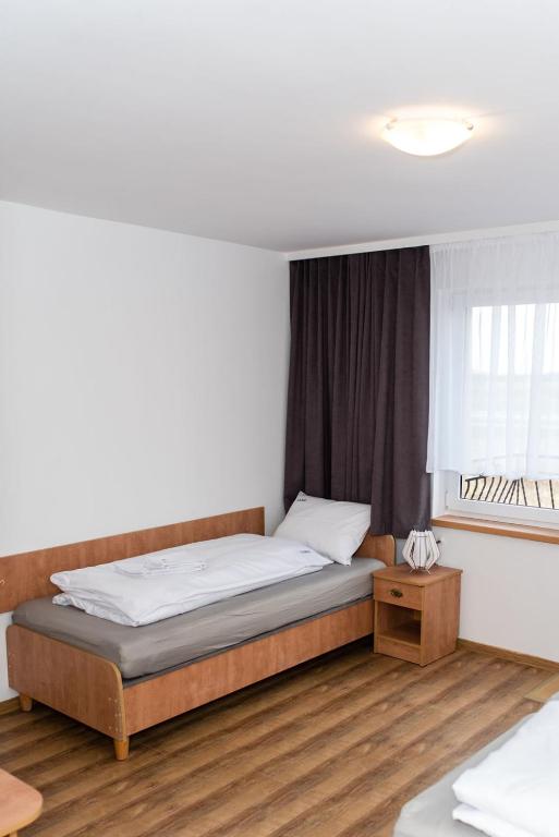Postel nebo postele na pokoji v ubytování Dom Wczasowy Larix