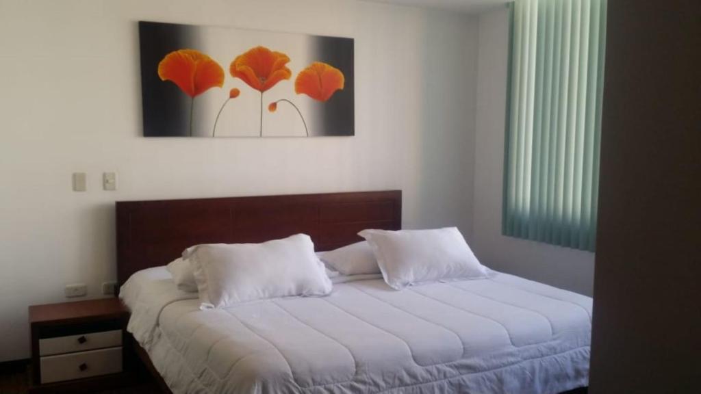 Misuitehotel La Carolina Quito tesisinde bir odada yatak veya yataklar