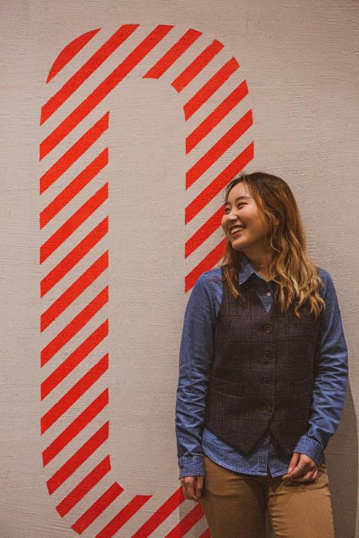 a woman standing in front of a red and white sign at TOC Hostel Barcelona in Barcelona