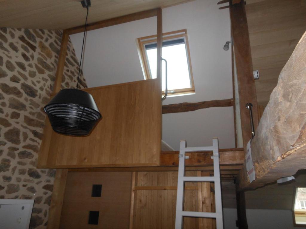 a room with a bunk bed and a ladder at Le Logis de Mordreuc in Pleudihen