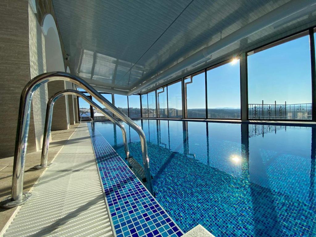 a large swimming pool with a blue railing at Complex Bolyarsko selo & Spa in Arbanasi