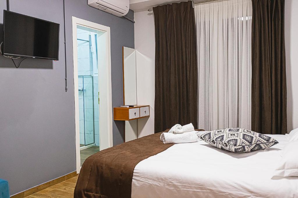 Postel nebo postele na pokoji v ubytování Olivar Hotel Tirana