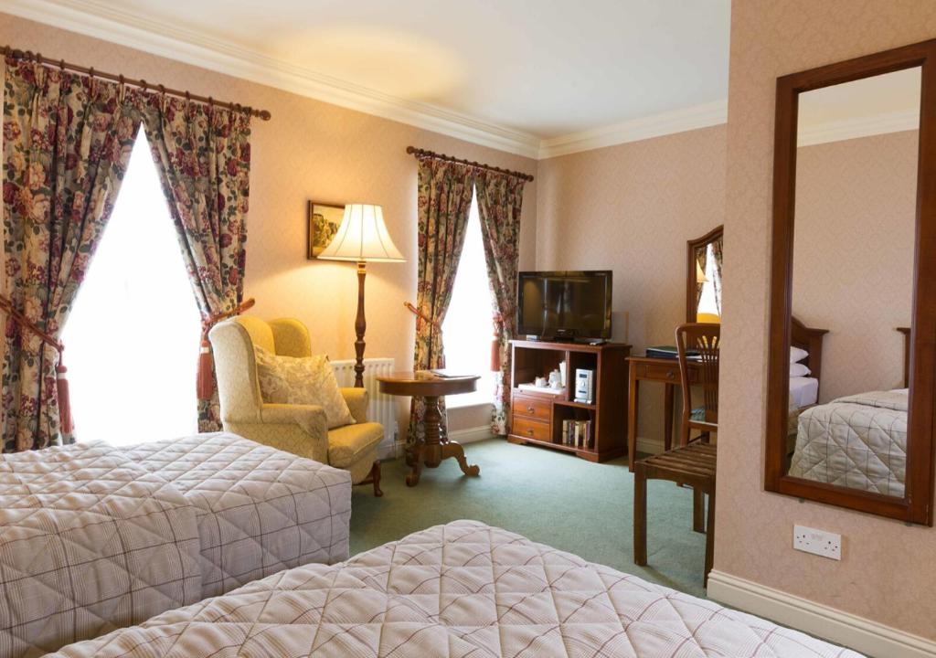 Postel nebo postele na pokoji v ubytování Sheedy's Boutique Hotel