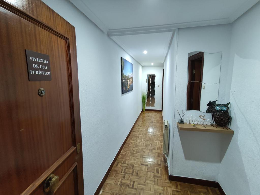 a hallway with a wooden door and a hallway with a hallway at Apartamentos Avenida de la paz 2 in Logroño