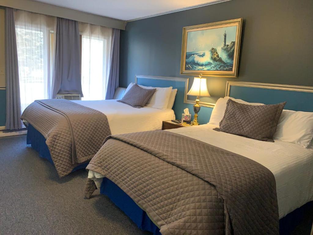 Postel nebo postele na pokoji v ubytování Starlite Motel & Suites