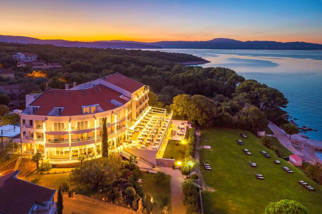 a large building with a view of the ocean at Spa & Wellness Hotel Pinia in Malinska
