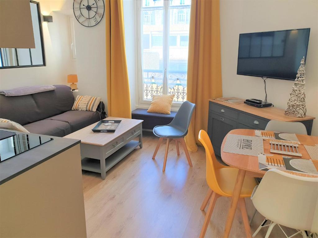 ein Wohnzimmer mit einem Sofa und einem Tisch in der Unterkunft HYPERCENTRE/LAMARTINE APPART 211 in Nizza