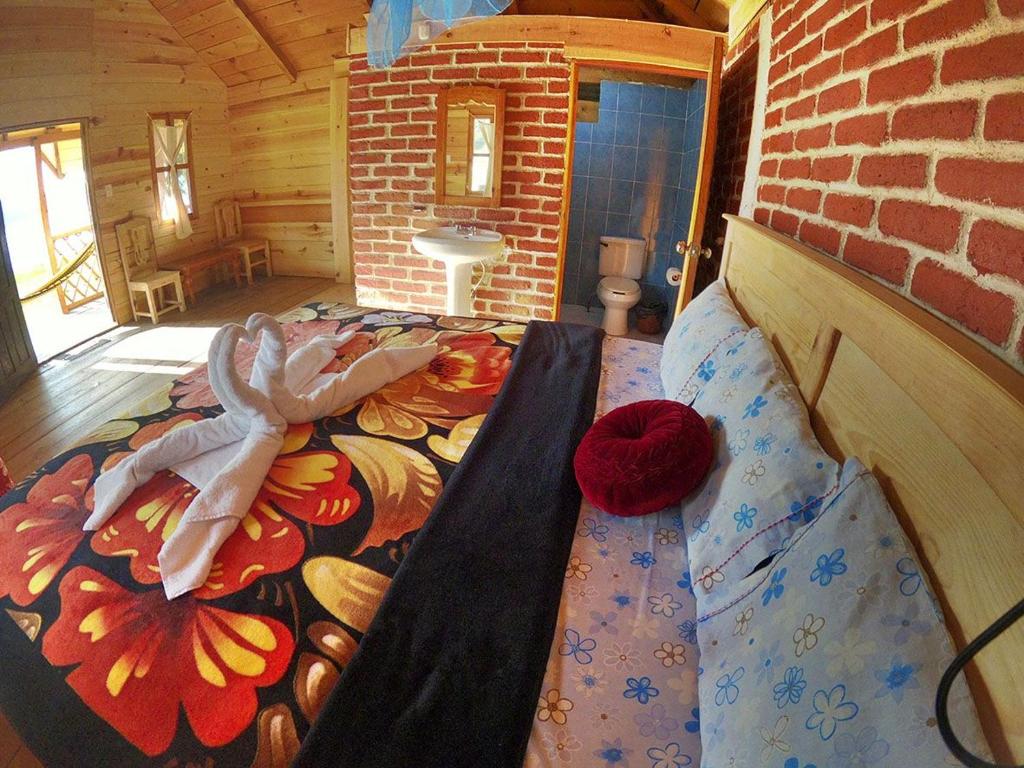 Postel nebo postele na pokoji v ubytování Cabañas Paraiso tziscao