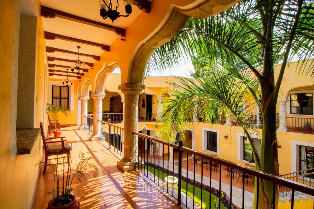 an indoor balcony of a house with palm trees at Hotel Montejo in M&eacute;rida