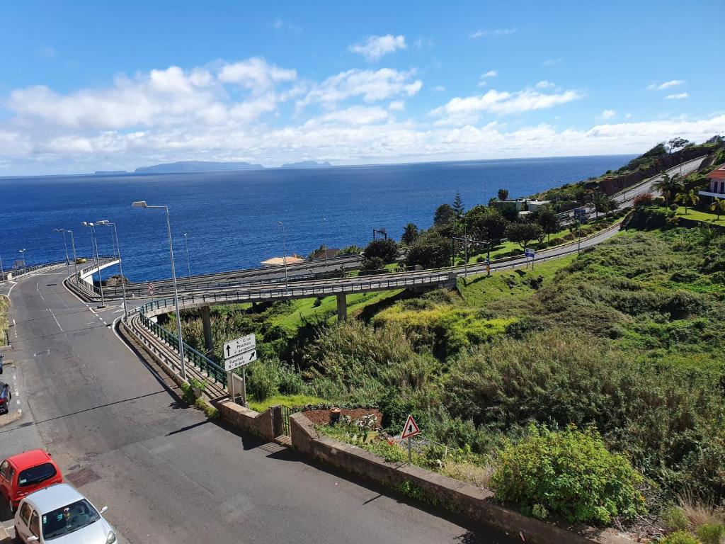 a view of a road with a bridge over the ocean at SAO PEDRO APARTMENT in Santa Cruz