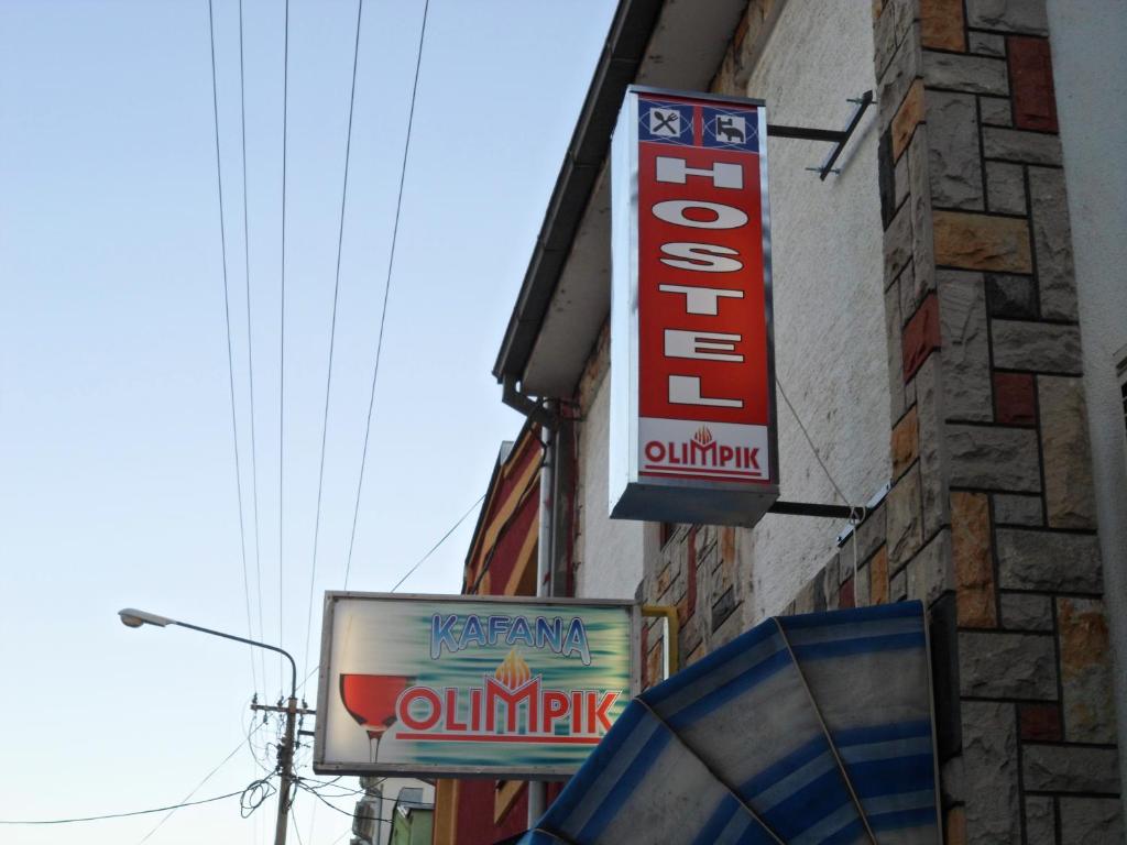 a group of signs on the side of a building at Hostel Olimpik in Negotin