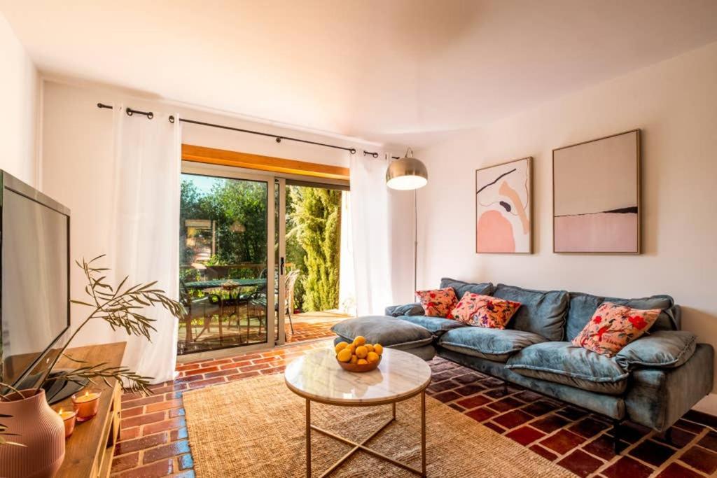 a living room with a blue couch and a table at Country chic duplex in Algarve in Pêra