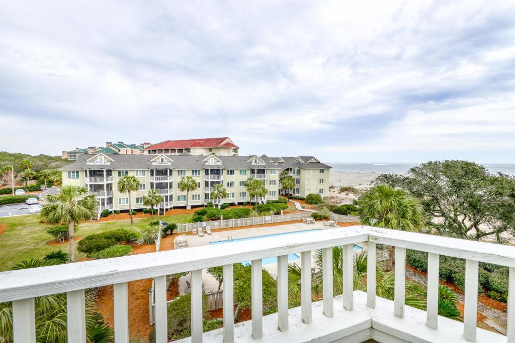a view from the balcony of a large house with a pool at Port O'Call C-303 in Isle of Palms