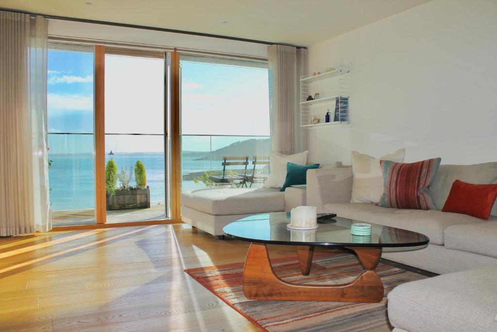 a living room with a couch and a table at Endcliffe in Falmouth