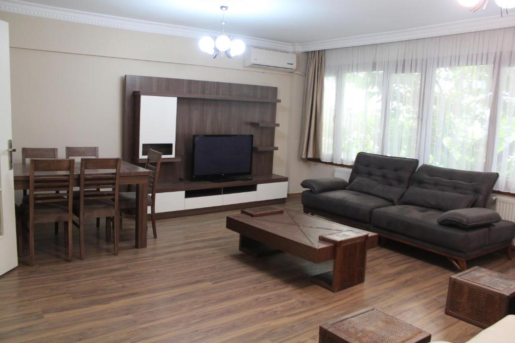 a living room with a couch and a table at Bedir Comfortable Apartment 120m to Taksim Square in Istanbul