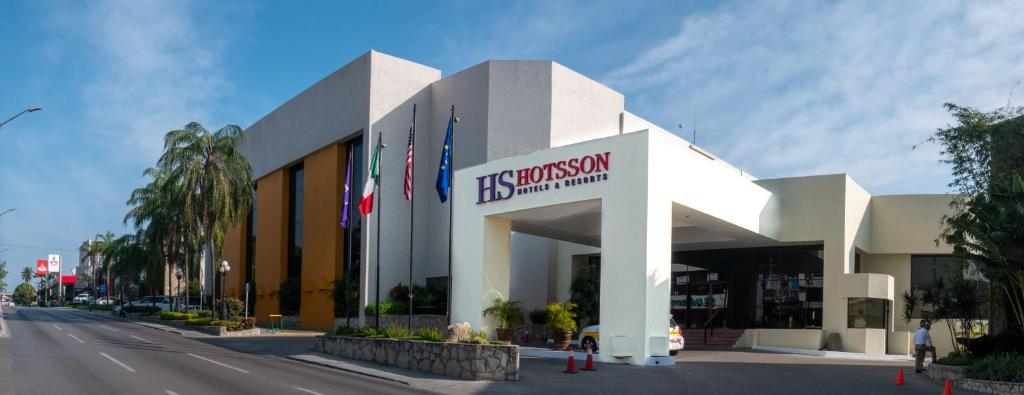 a building with a sign on the side of a street at HS HOTSSON Hotel Tampico in Tampico