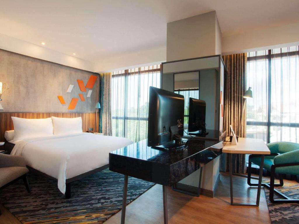 Postel nebo postele na pokoji v ubytování ibis Styles Medan Pattimura