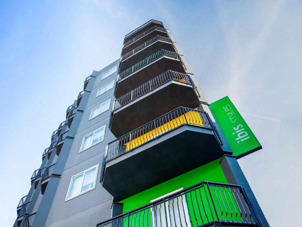 a tall building with a green and black at Ibis Styles Brindisi in Brindisi