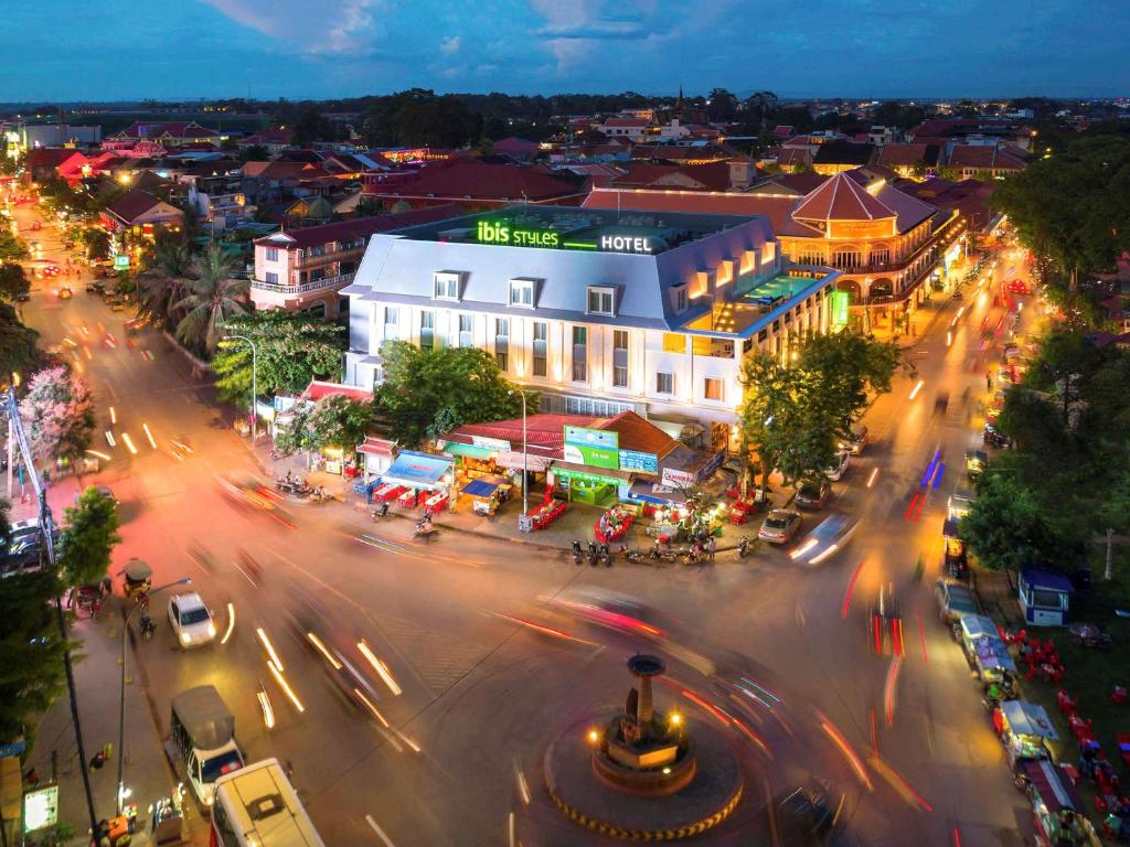 uma vista panorâmica de uma movimentada rua da cidade à noite em ibis Styles Siem Reap em Siem Reap