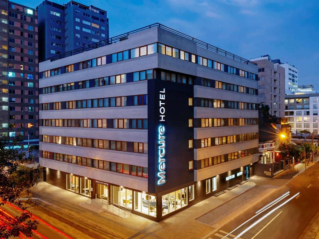 a building with a sign on the side of it at Mercure Ariosto Lima in Lima