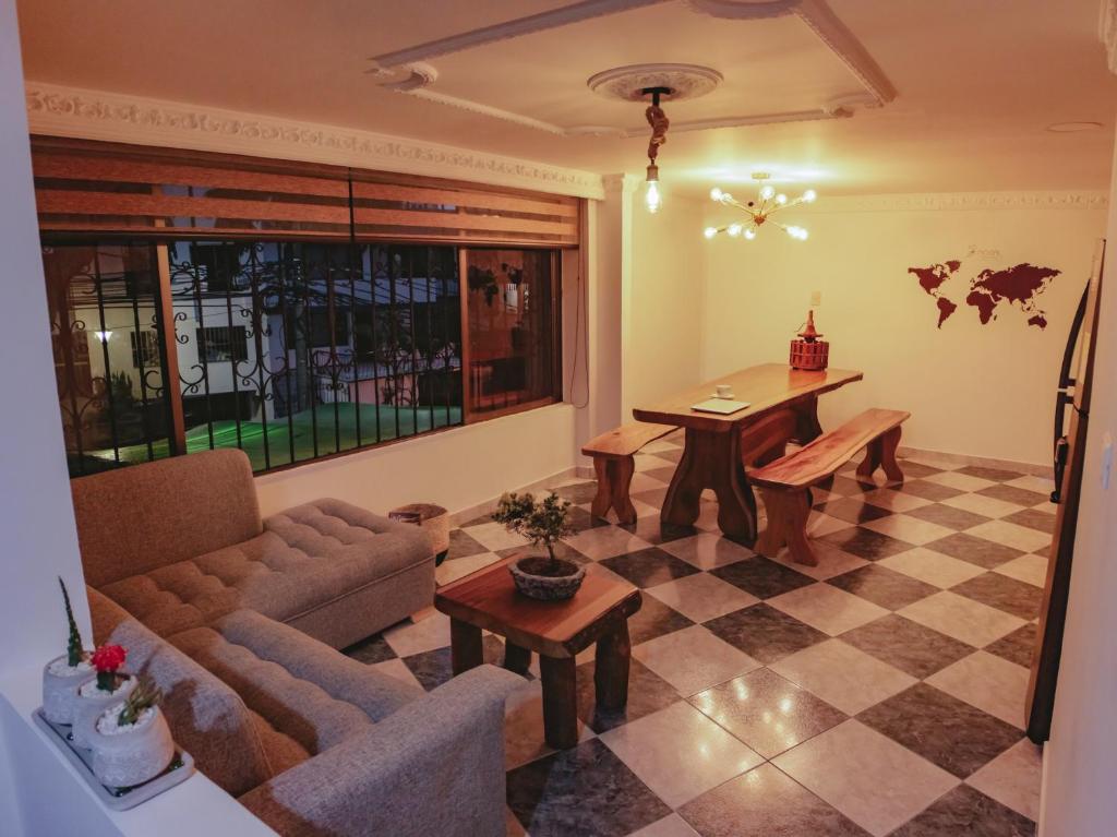 a living room with a couch and a table at NOGAL HOSTEL in Pereira