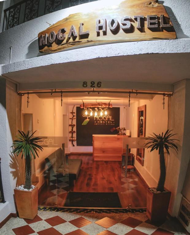 a lobby of a hotel with two palm trees at NOGAL HOSTEL in Pereira