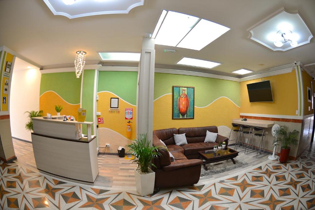a living room with a couch and a tv at La Hermosa Hotel in Buga